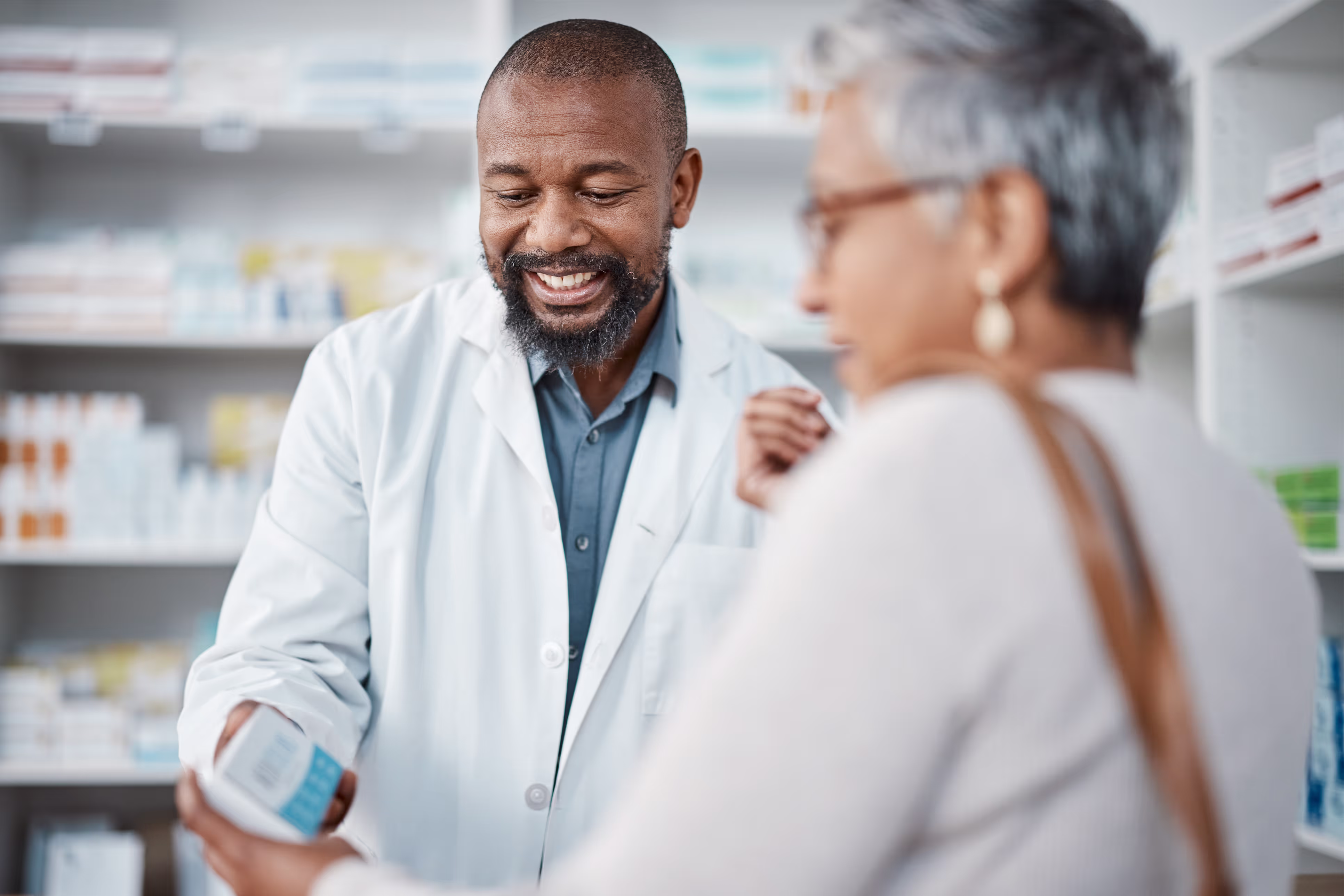 2 Doctors in a medical store holding a medicine