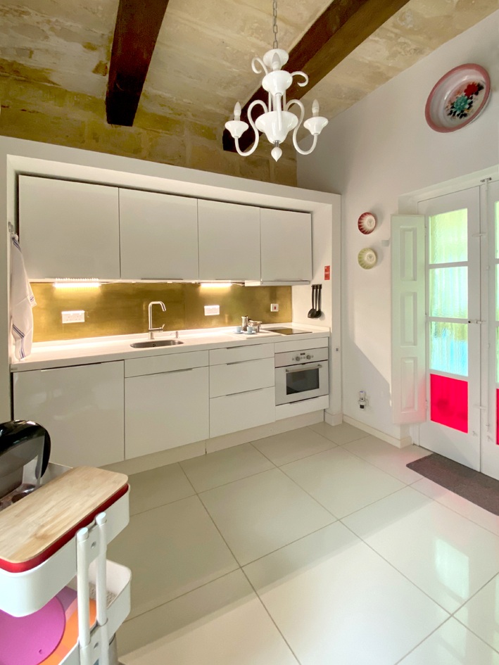 Kitchen with brass splashback. Sale property with separate kitchen
