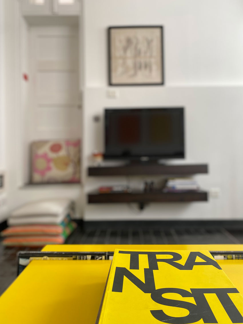Detail of sitting room with TV set in background.