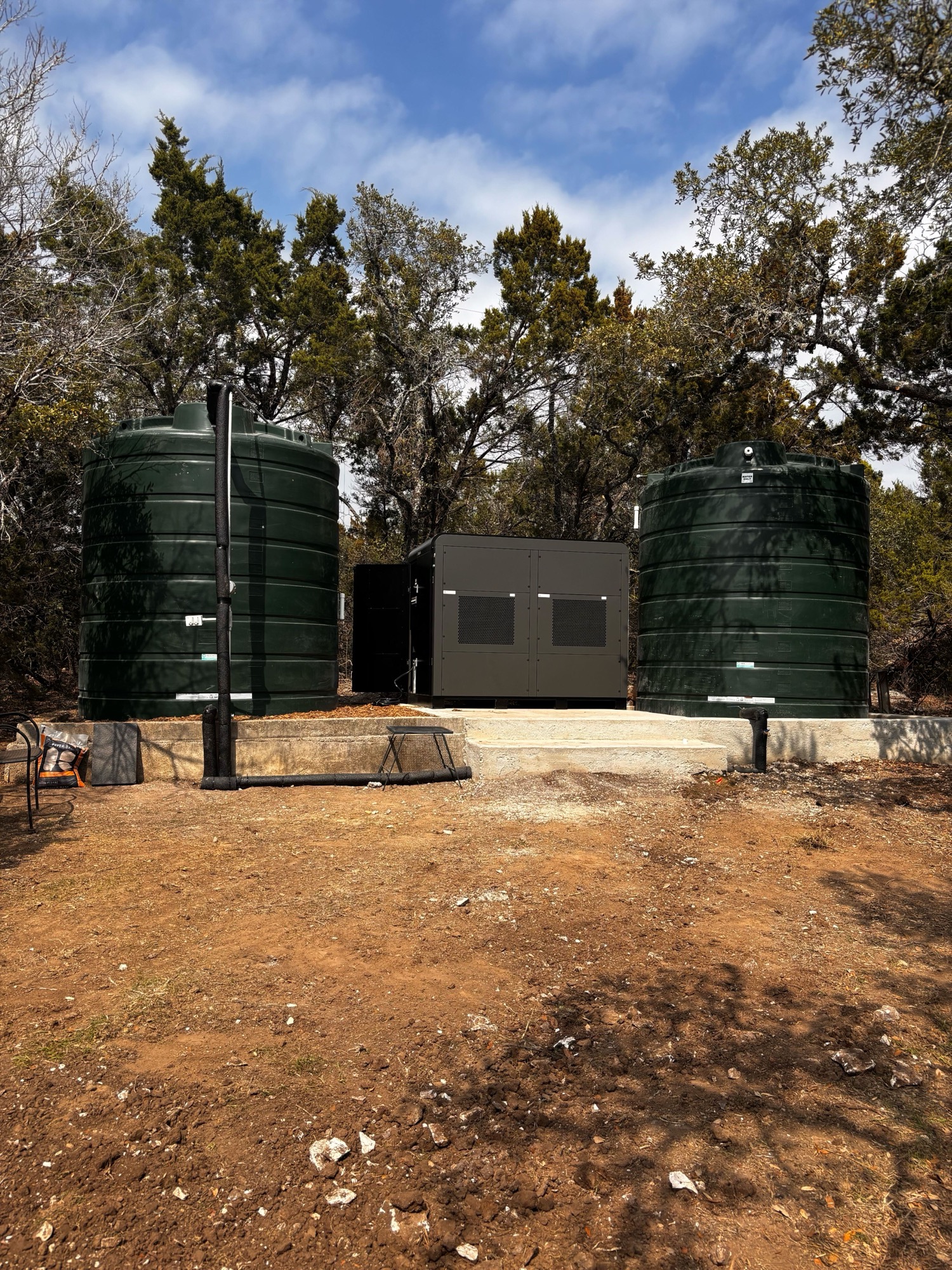 Aquaria Hydropack installed at a Texas home with two water storage tanks