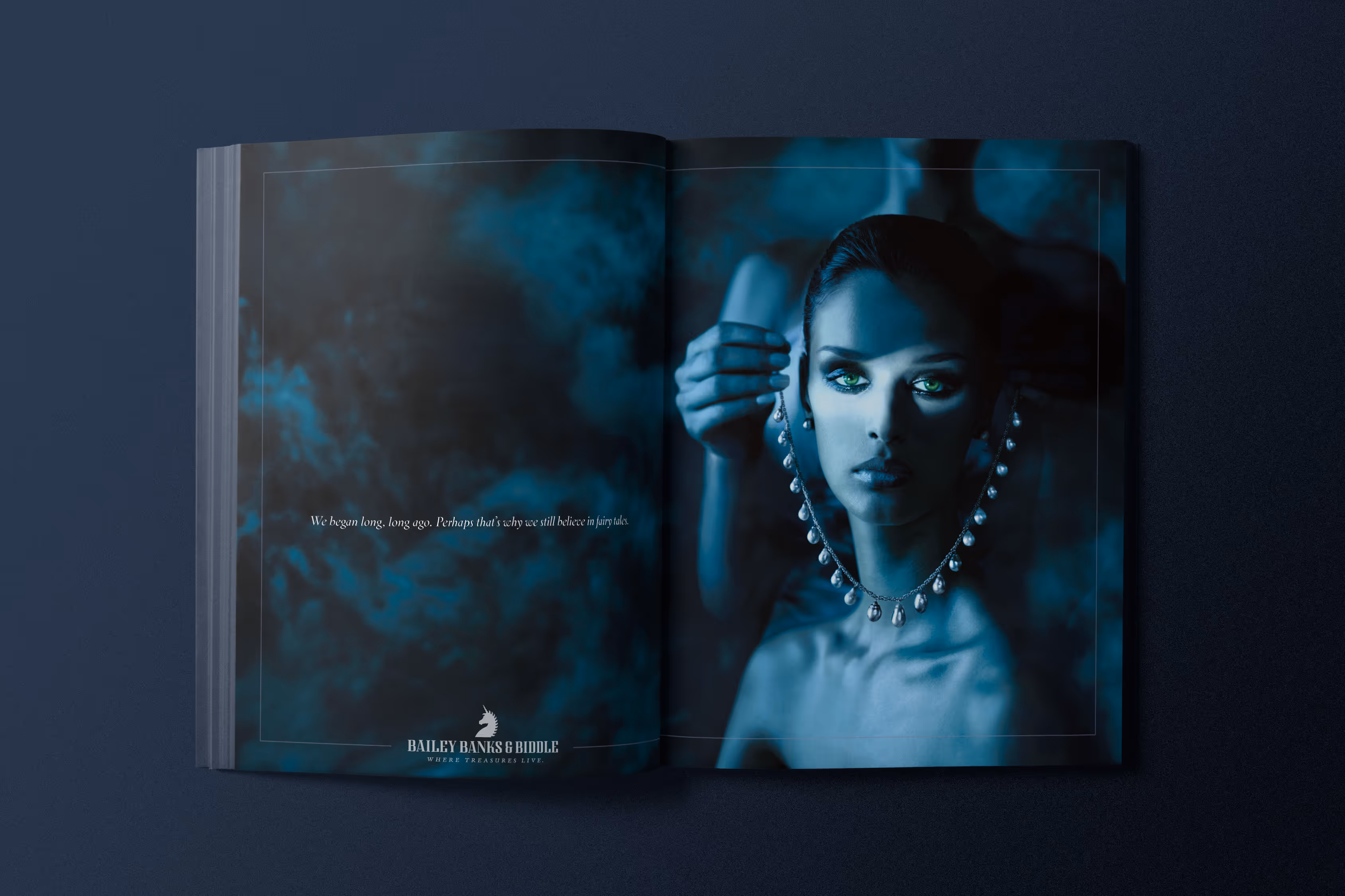 Magazine spread for Bailey, Banks & Biddle. Stylized blue to highlight the jewelry on a model. A pearl necklace.