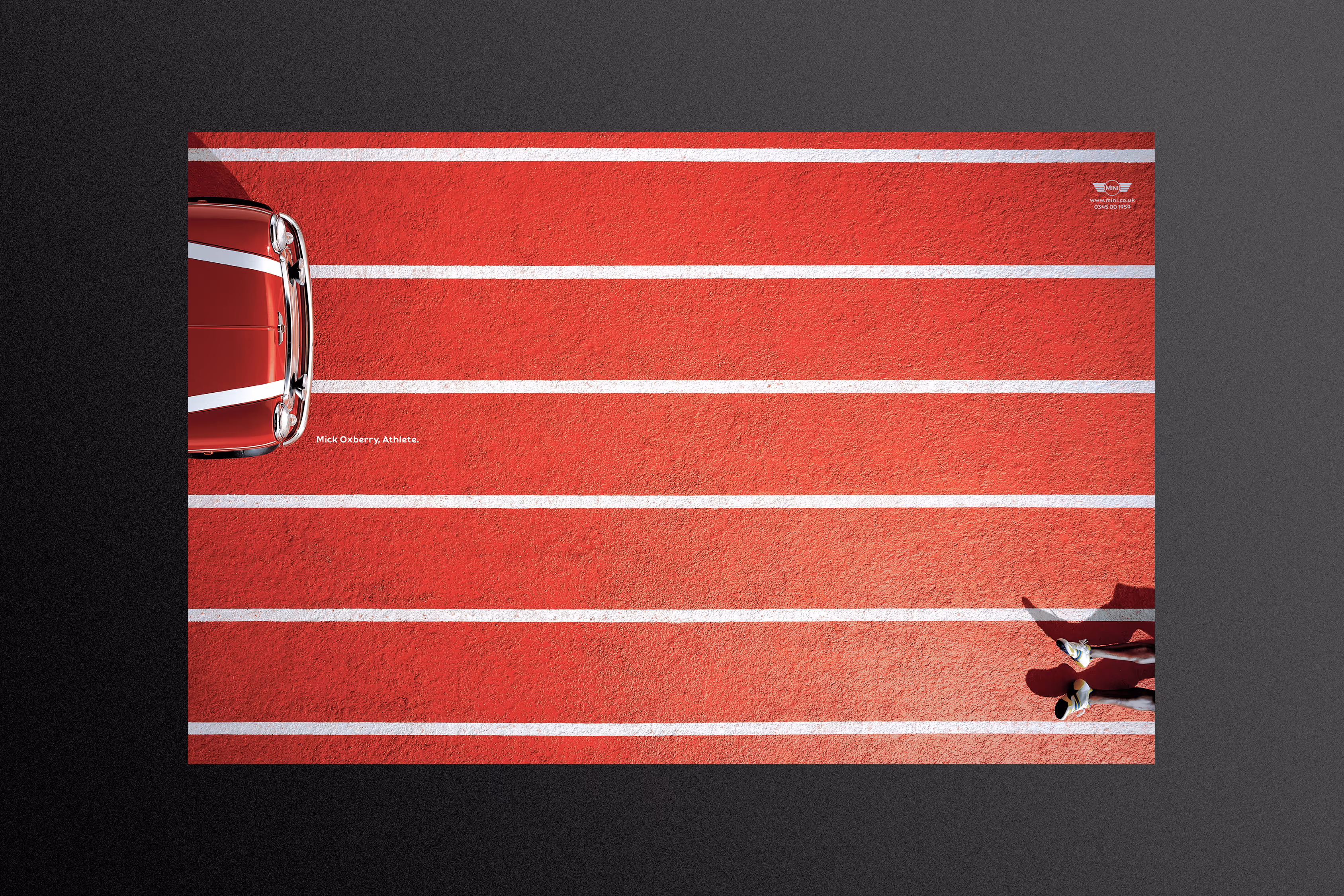 Mini ad with white stripes on the bonnet/hood that align with a running track.