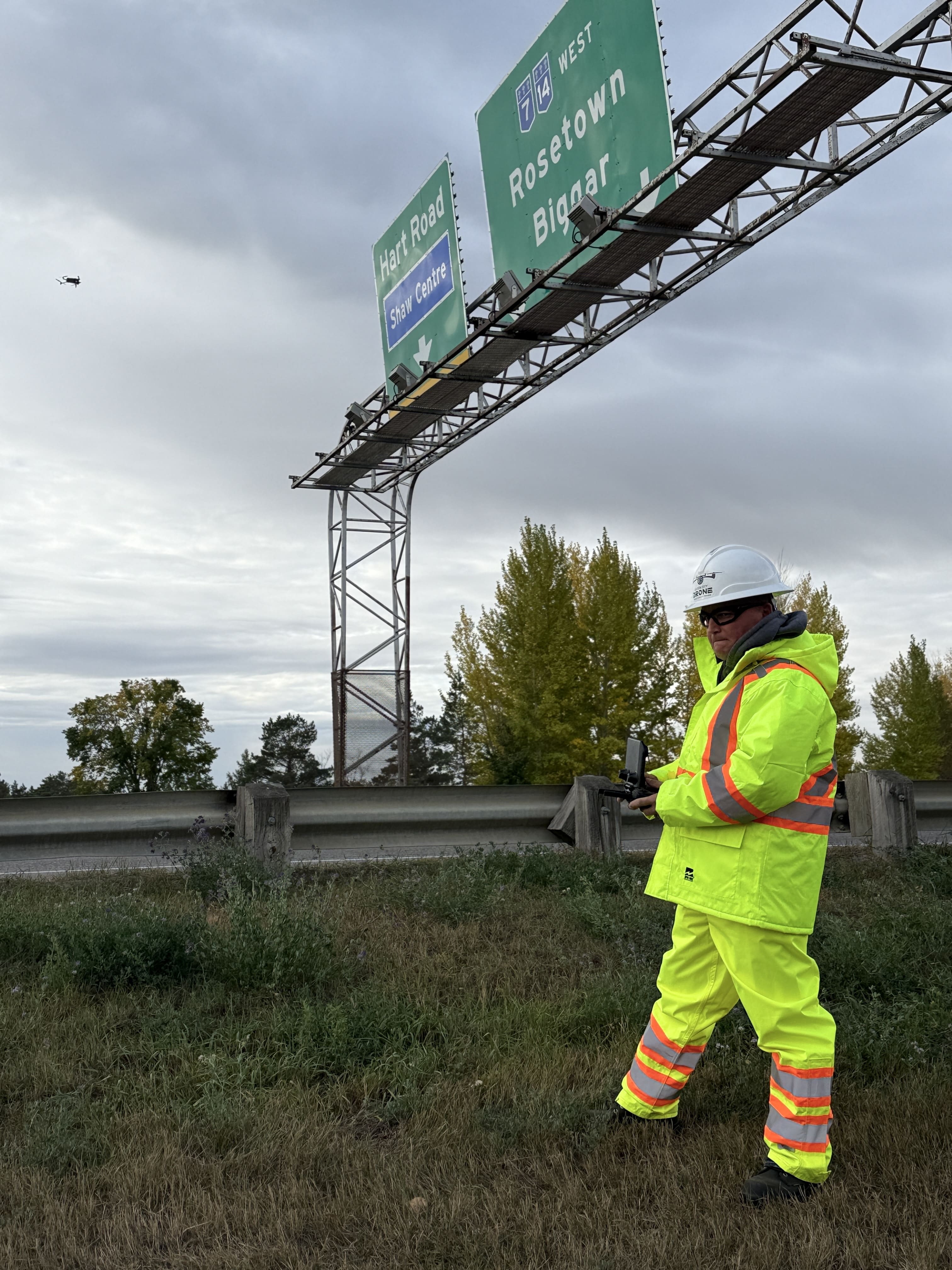 Drone-based sign face review conducted by a certified inspector holding an Advanced Operations Pilot Certificate to evaluate clearance, panel condition, and access.