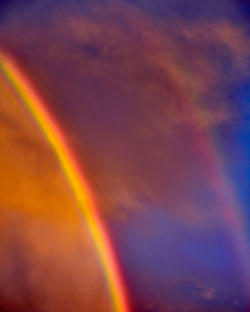 A double Hawaiian rainbow and sunset clouds.