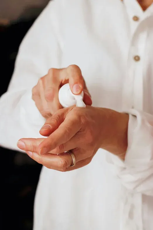 Gloved hand holding a personal care product sample