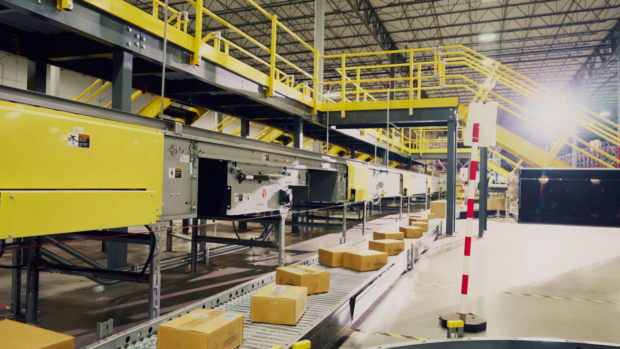 Automated conveyor belts sorting parcels inside a warehouse.