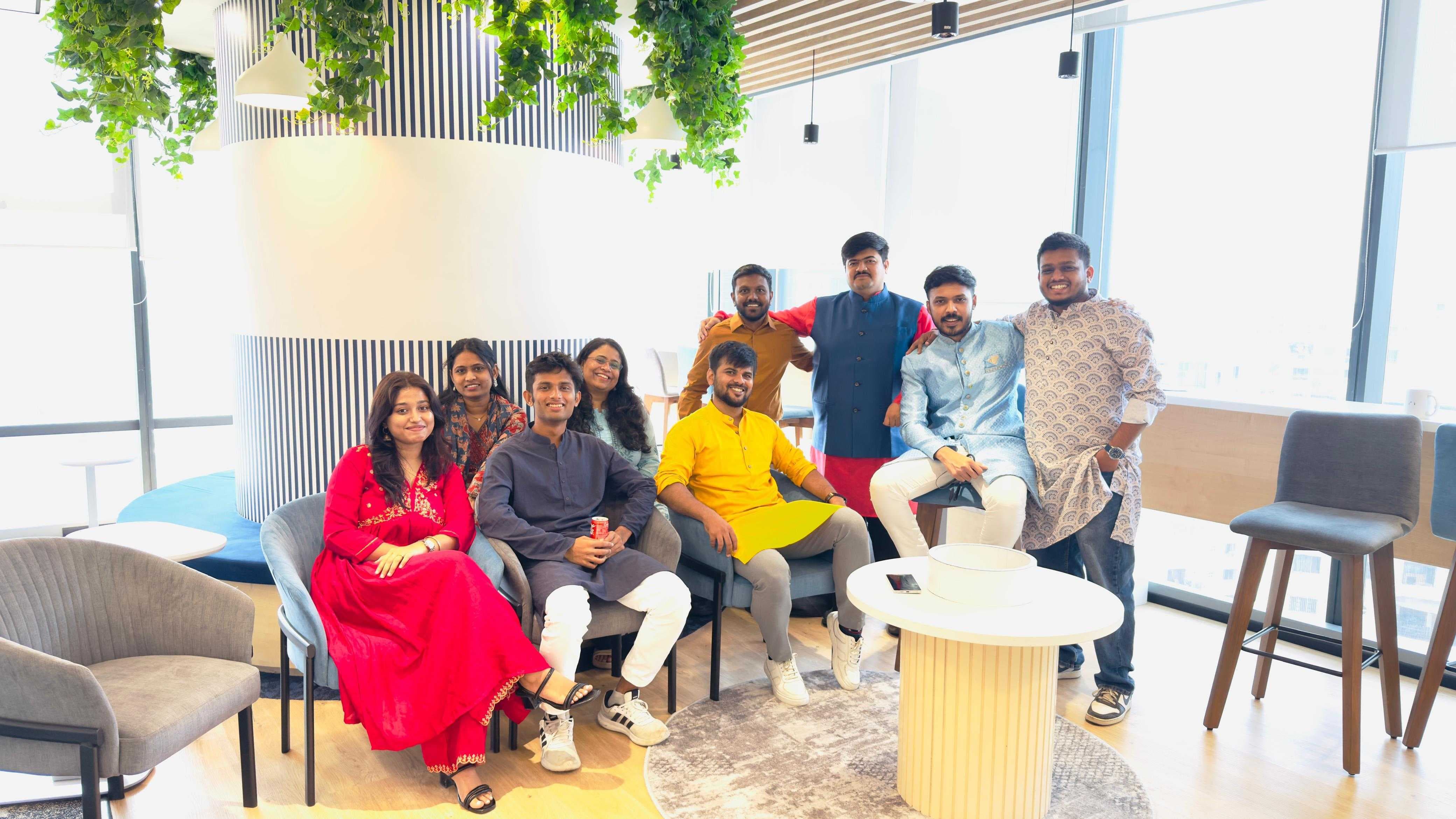 Group of Pattern India colleagues in festive traditional clothing smiling together in the Pune office lounge