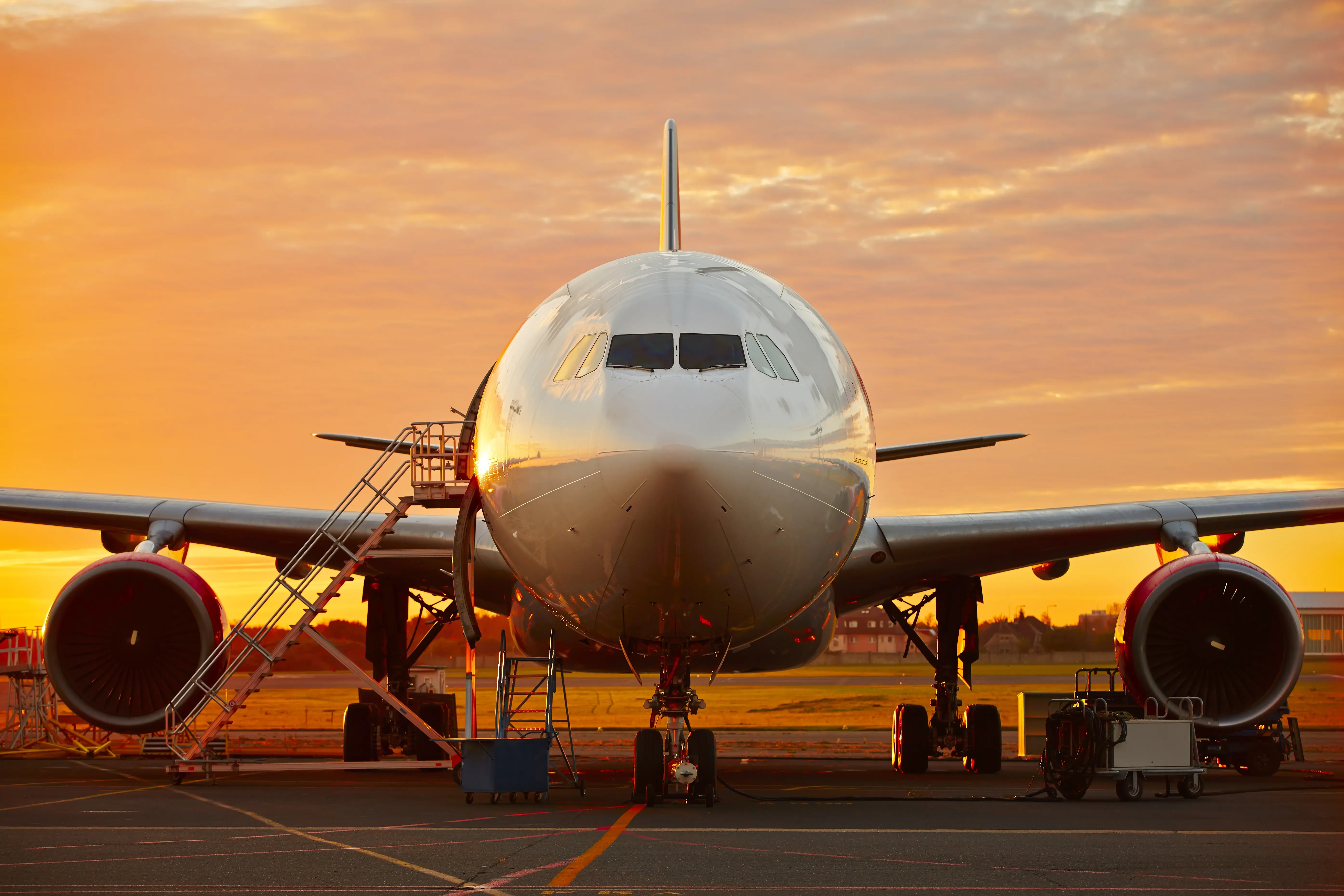 Airplane with a sunset backdrop, representing international repatriation services.