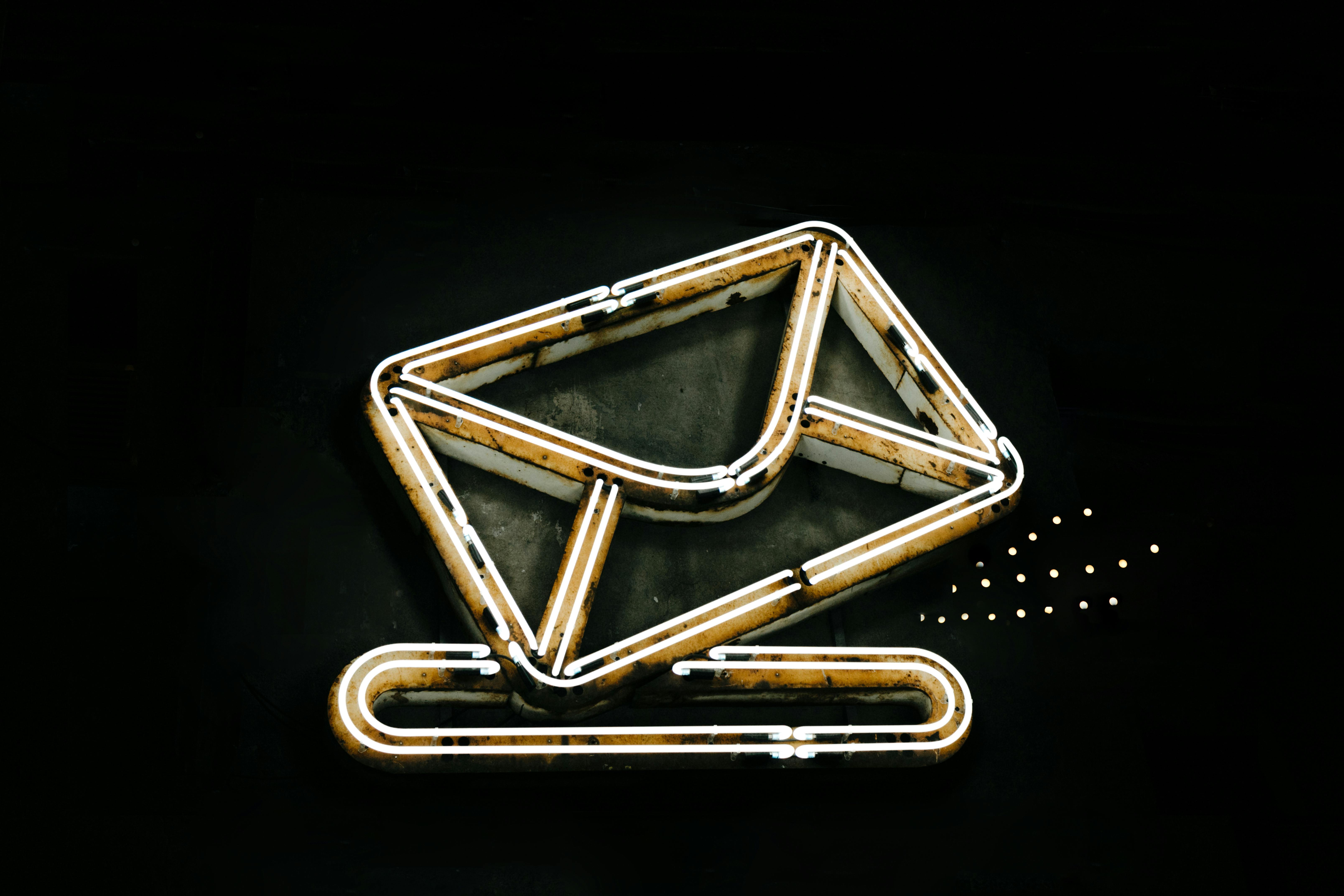 Glowing neon envelope symbol representing email technology