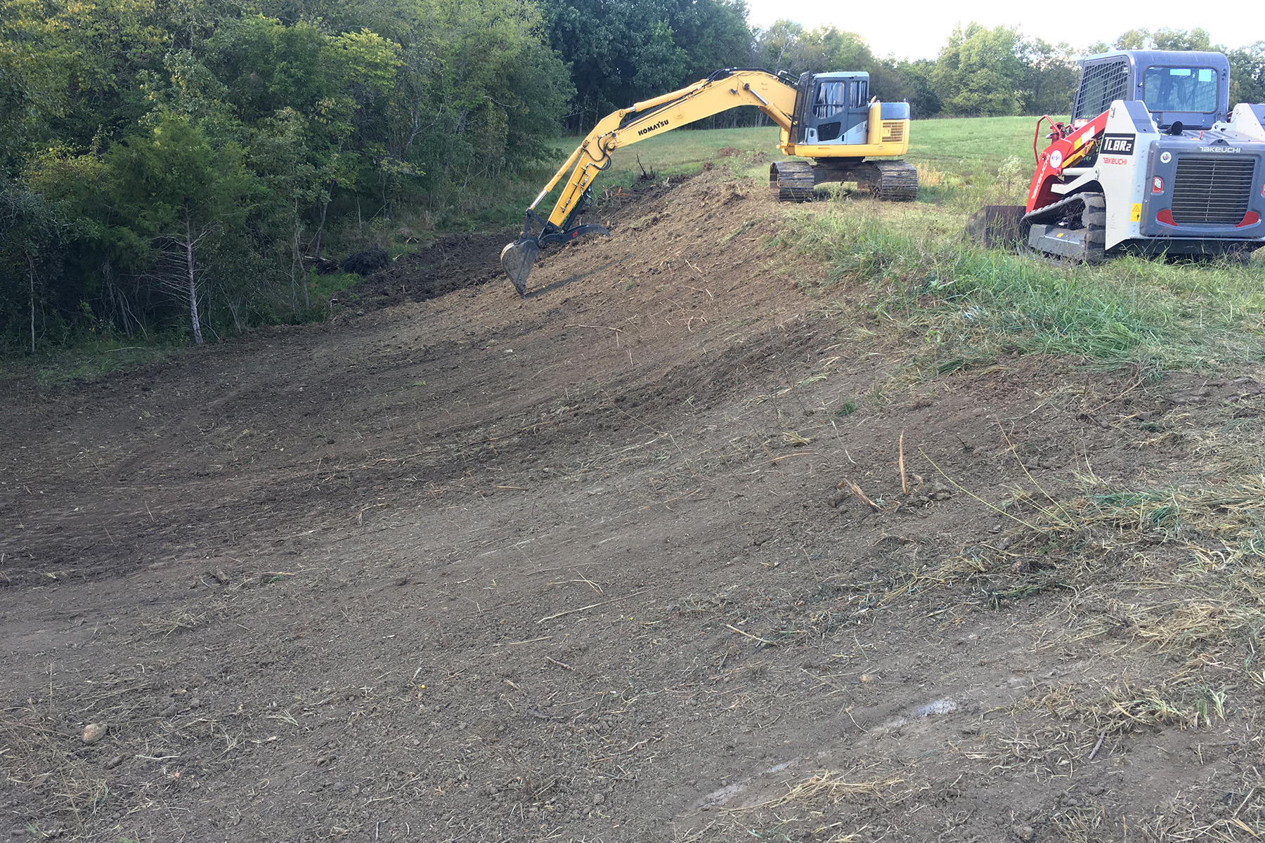 Image of machine grading an embankment