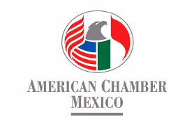 Logo of American Chamber Mexico featuring an eagle, red and white stripes, and green bars in a circular design.