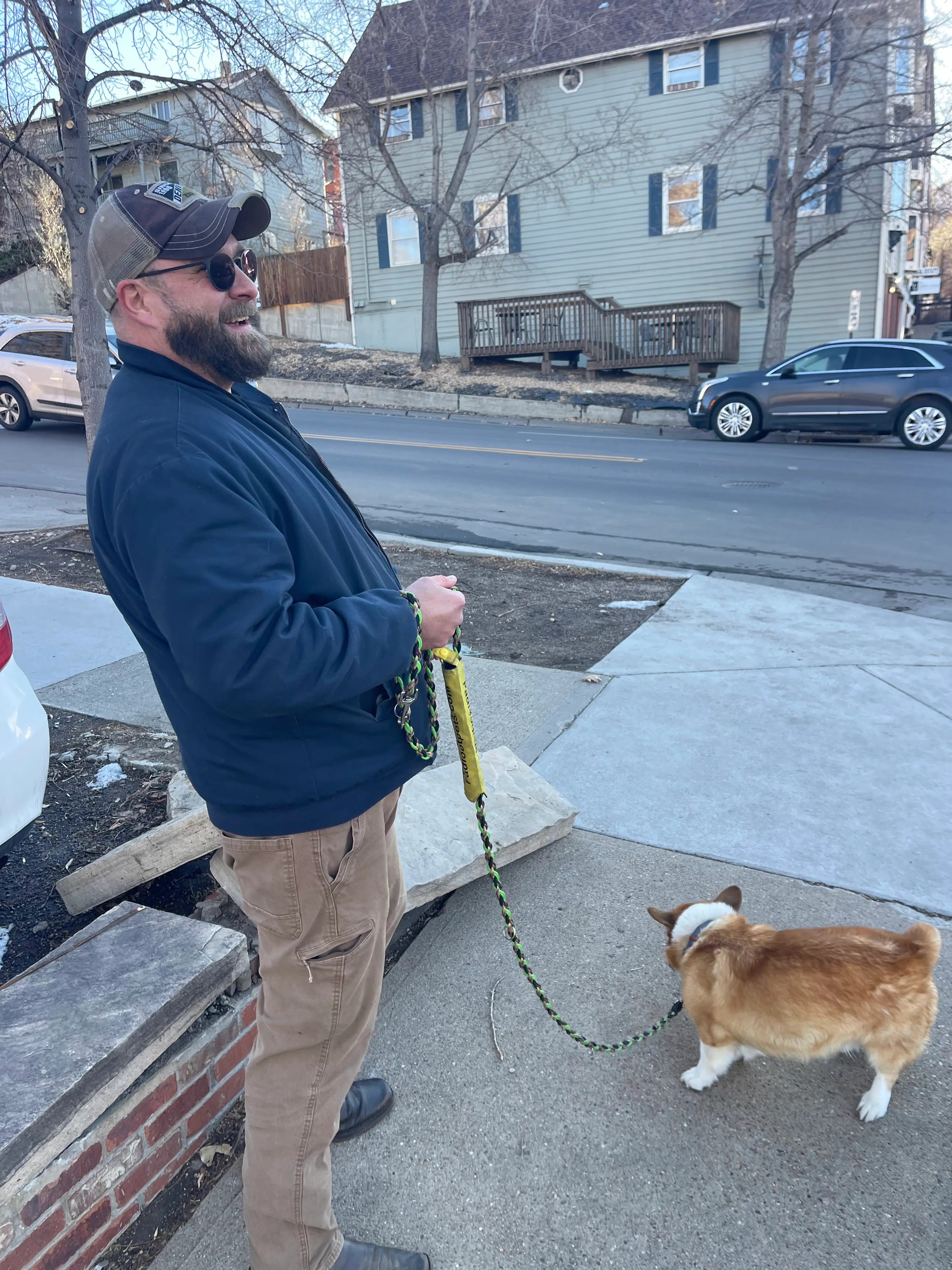 A Padfoot Pets trainer practicing urban focus and engagement with a dog on a busy sidewalk