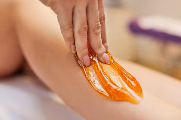 Sugaring hair removal on legs.