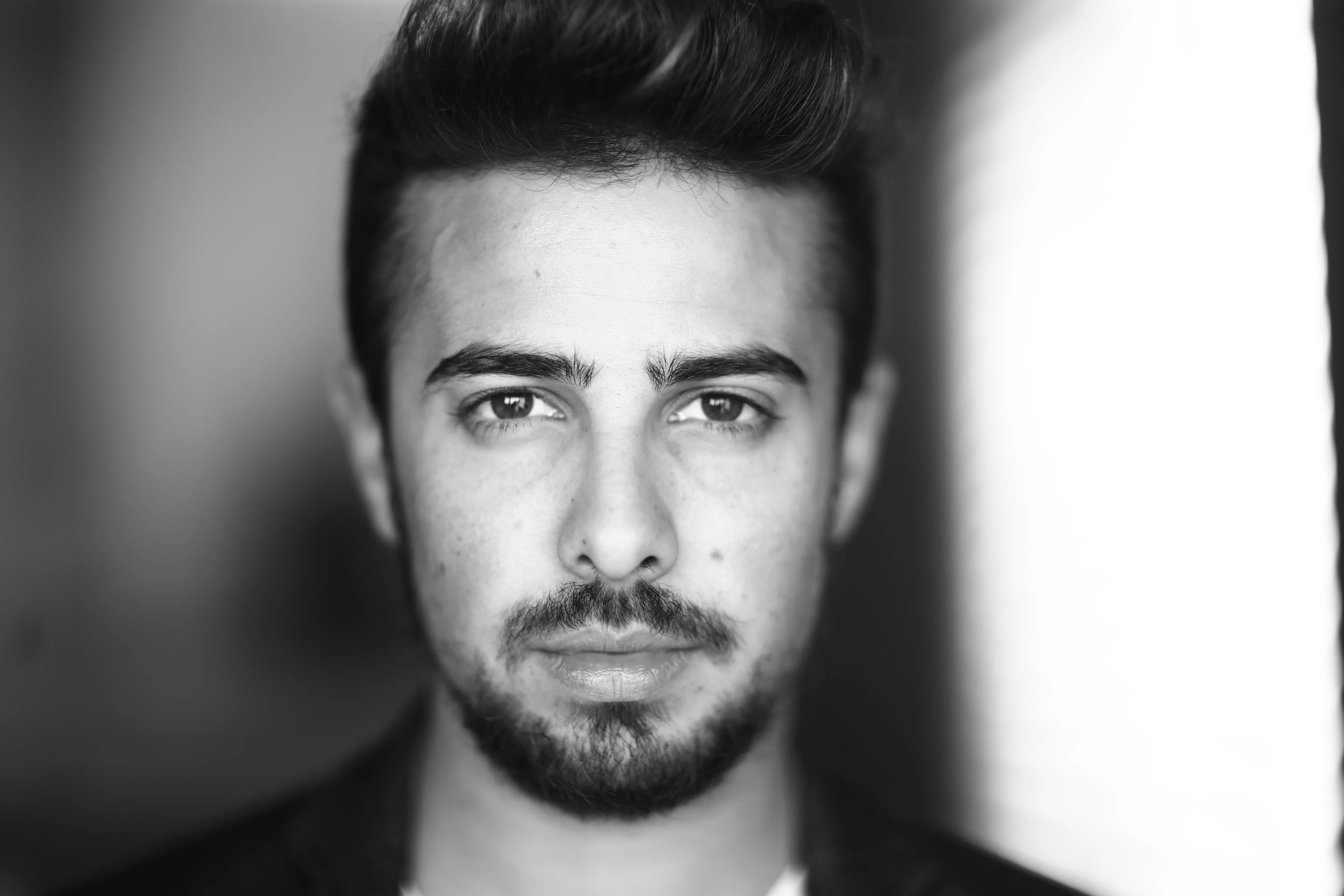 A black and white photo of Michael Alroy set as a background for the quote