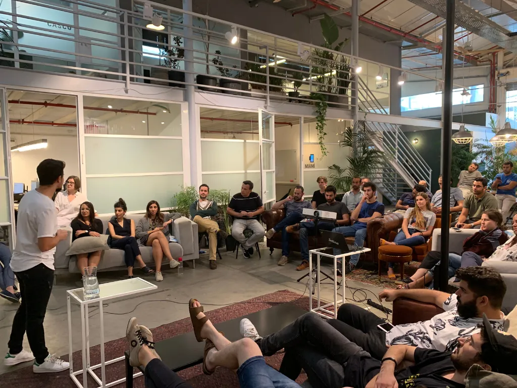 A photo selfie of Michael Alroy at the end of his talk with people in the background