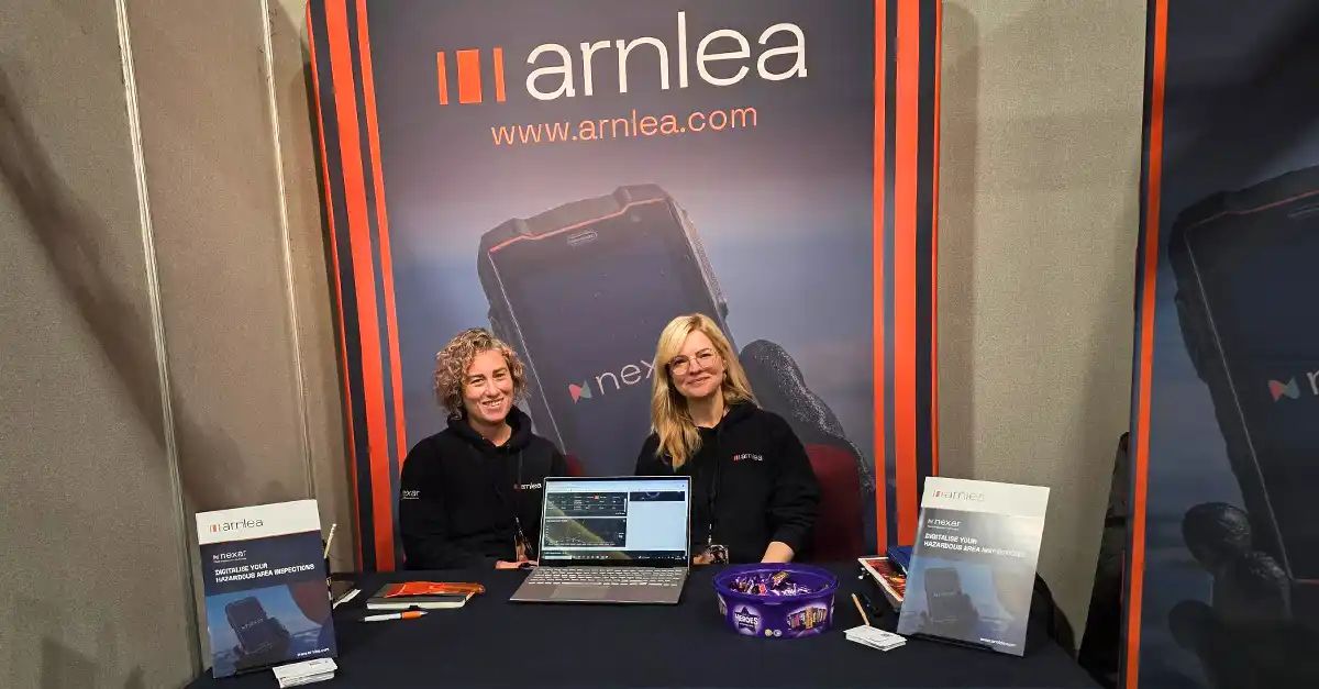 Claire Murray and Jen Hughes from Arnlea smiling at their exhibition stand at The Safety Expo 2025 at P&J Live in Aberdeen, surrounded by Nexar promotional materials.