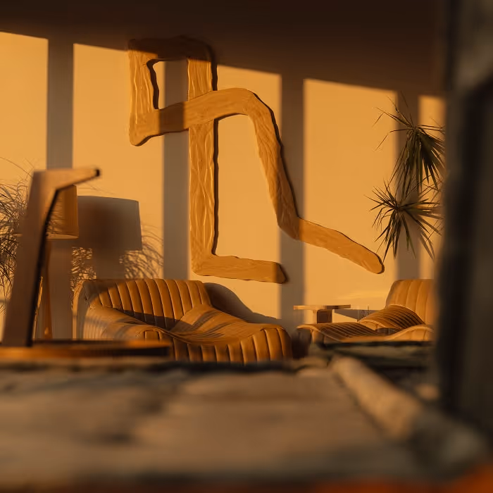 Cozy lounge with tan leather seating, abstract wooden wall art, and warm sunlight streaming through tall windows.