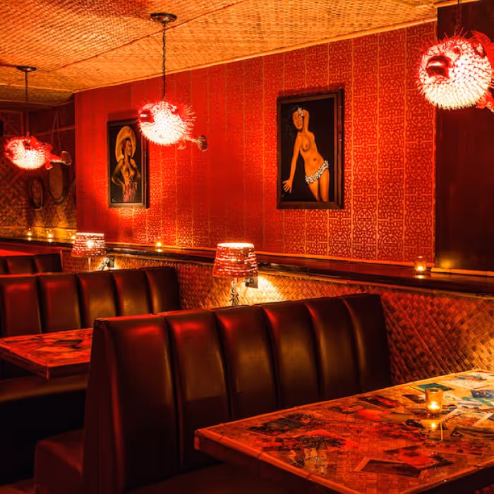 Bootlegger Tiki lounge with red leather booths, pufferfish pendant lights and tropical decor.