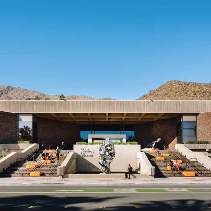 Palm Springs Art Museum modernist facade with outdoor sculpture and mountain backdrop.