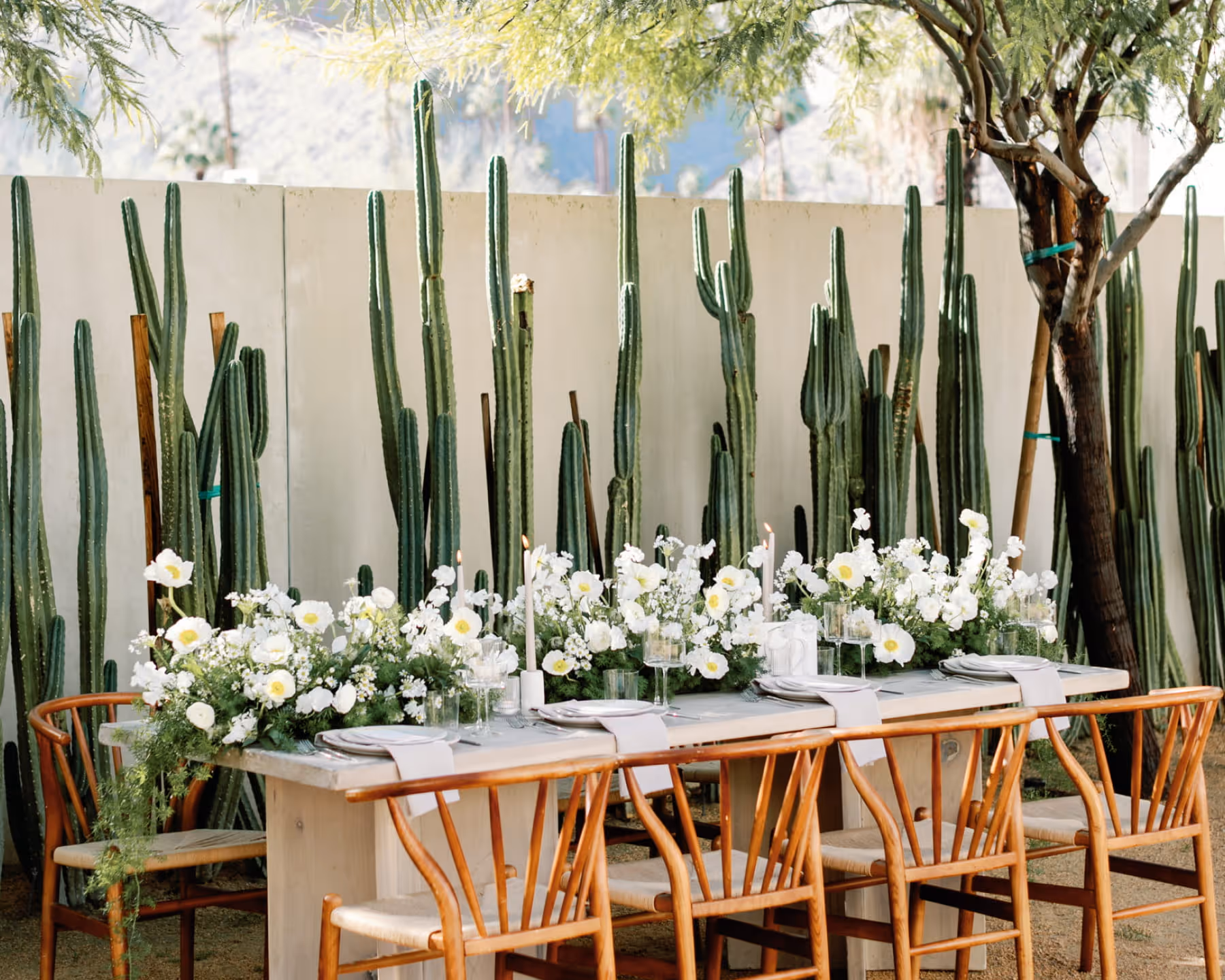 Bridesmaids in matching robes toasting with champagne while getting ready on wedding morning