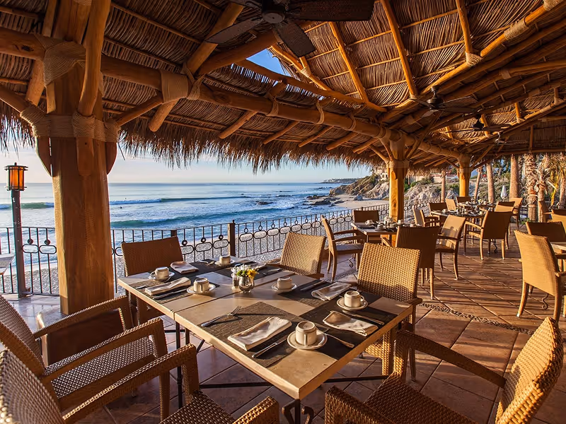 Open-air dining under palapas with ocean views at 7 Seas Seafood Grille along the Sea of Cortez