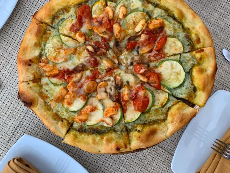 Wood-fired pizza topped with fresh ingredients served at La Forchetta Italian restaurant