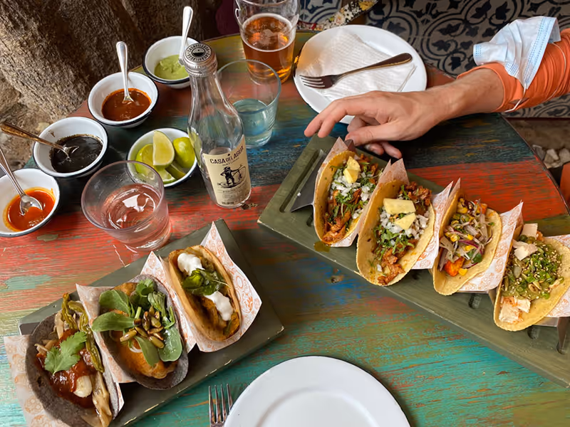Colorful spread of tacos, cold cervezas, and shared plates at La Lupita Taco and Mezcal cantina