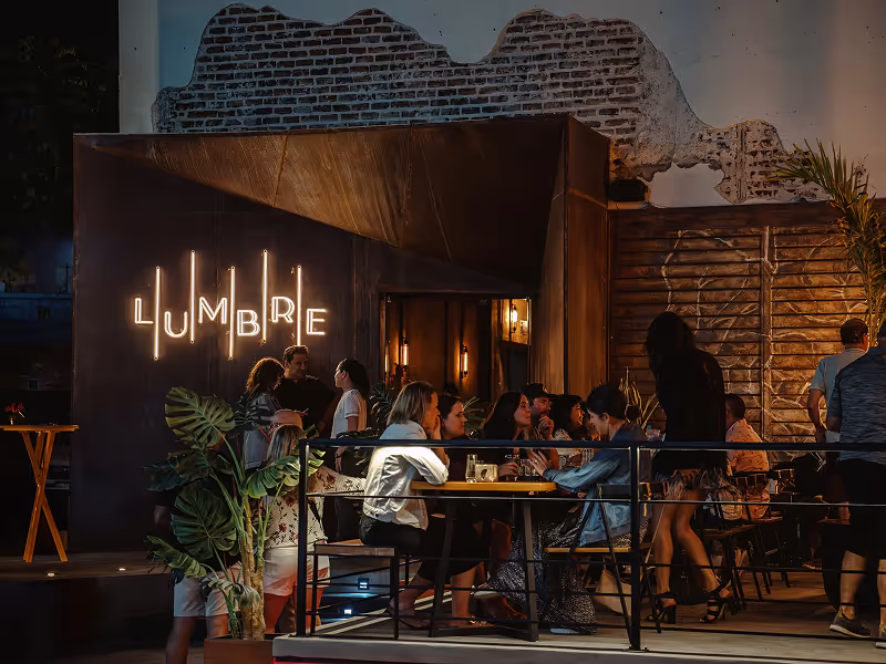 Warm interior of Lumbre restaurant with open fire kitchen and intimate dining atmosphere