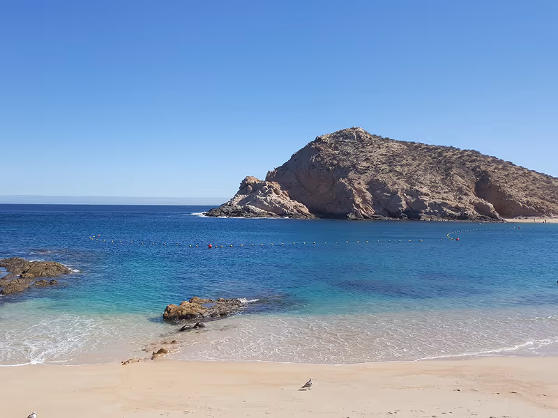 Aerial view of the secluded horseshoe-shaped cove of Santa Maria Beach with clear turquoise waters