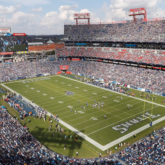Aerial view of Nissan Stadium packed with fans during a Tennessee Titans football game on a sunny day.