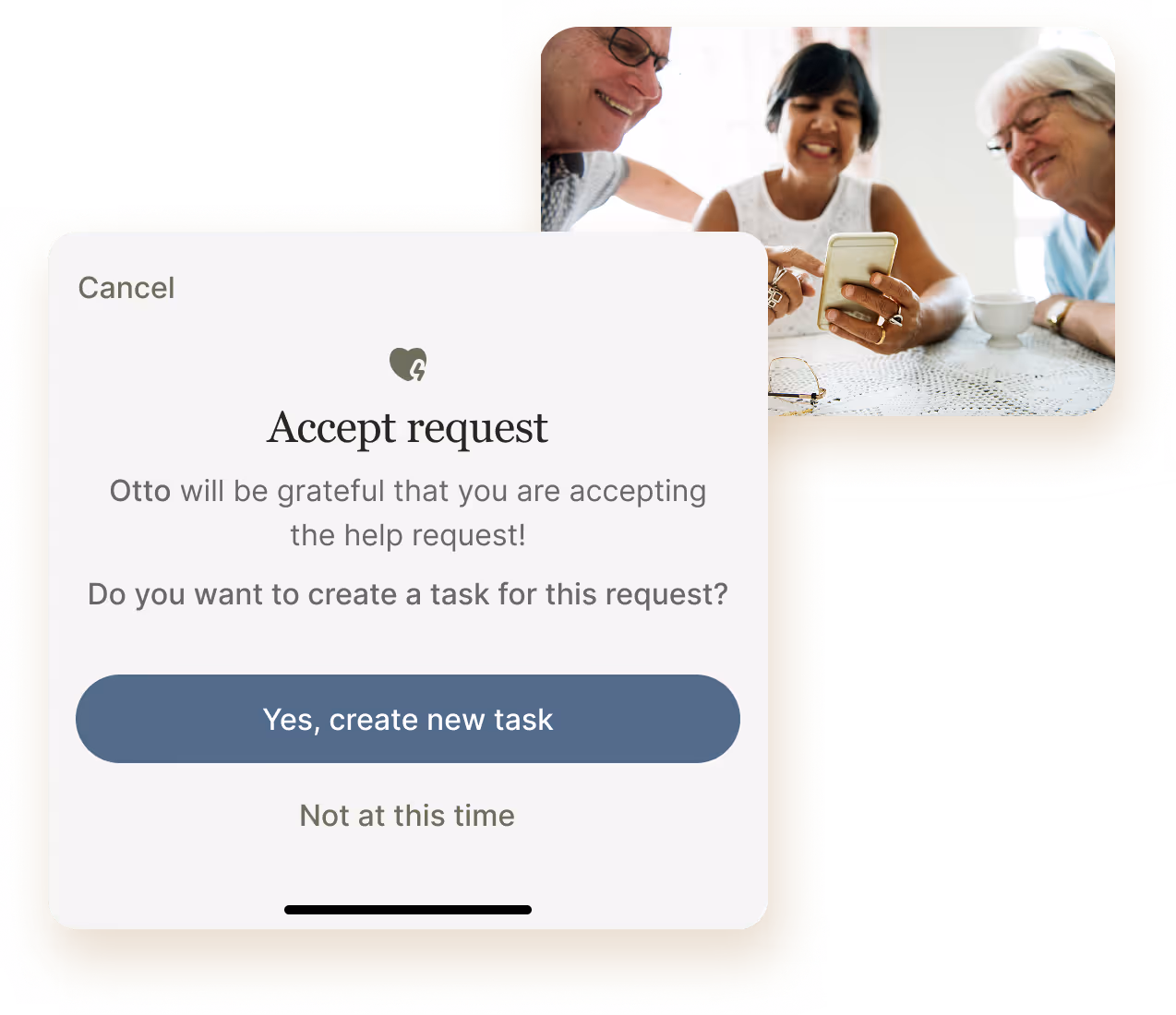 Three elderly people smiling and looking at a smartphone together over a table with a white lace tablecloth.