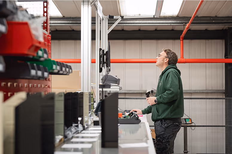 Warehouse worker operating machinery in industrial storage facility
