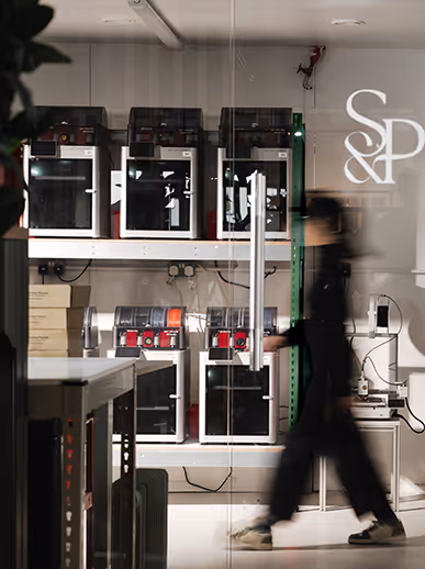 Blurry figure walks past scientific equipment and technical shelving