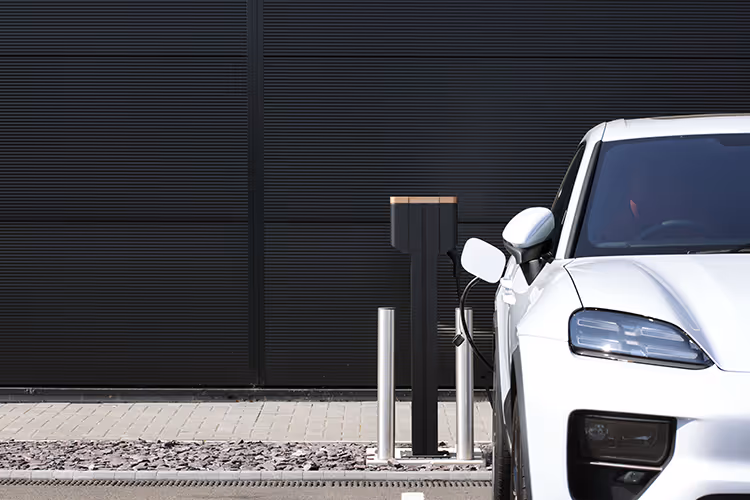 Voiture électrique blanche en charge dans une station moderne avec un fond sombre
