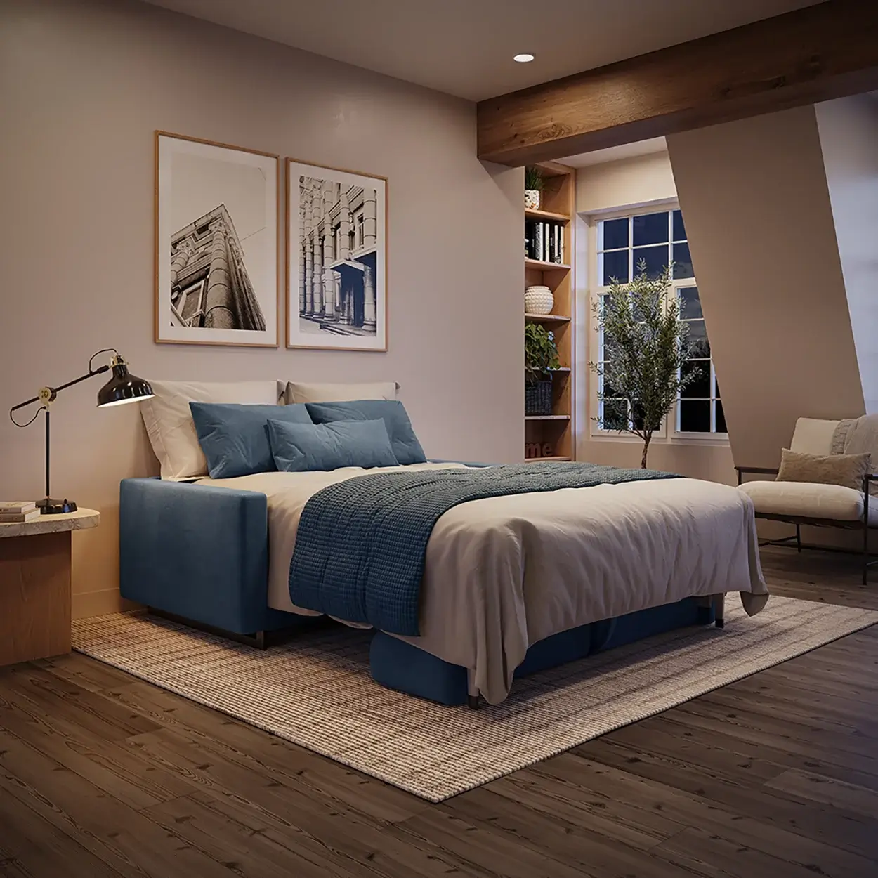 Modern bedroom with a blue upholstered bed dressed in beige and blue bedding, a wooden floor, beige walls, black adjustable desk lamp on a small wooden side table, two framed architectural prints on the wall, a window with a potted plant on the sill, and a beige cushioned chair with a pillow nearby.