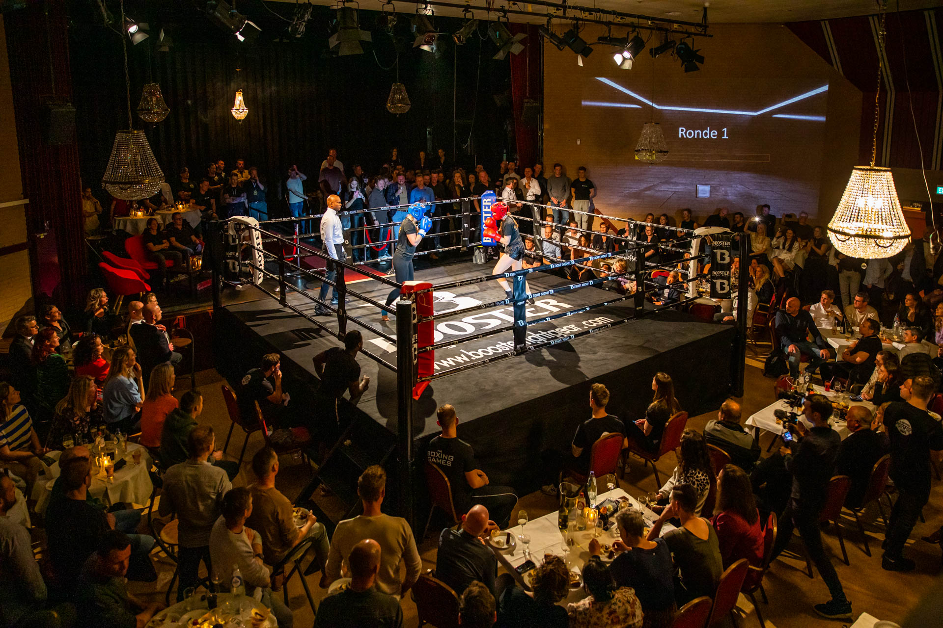 Kickboxing match in front of live audience.