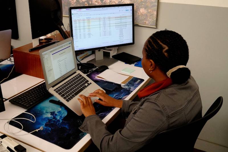 TUNL team member managing shipment bookings on dual screens, showing support for single and multi-piece orders