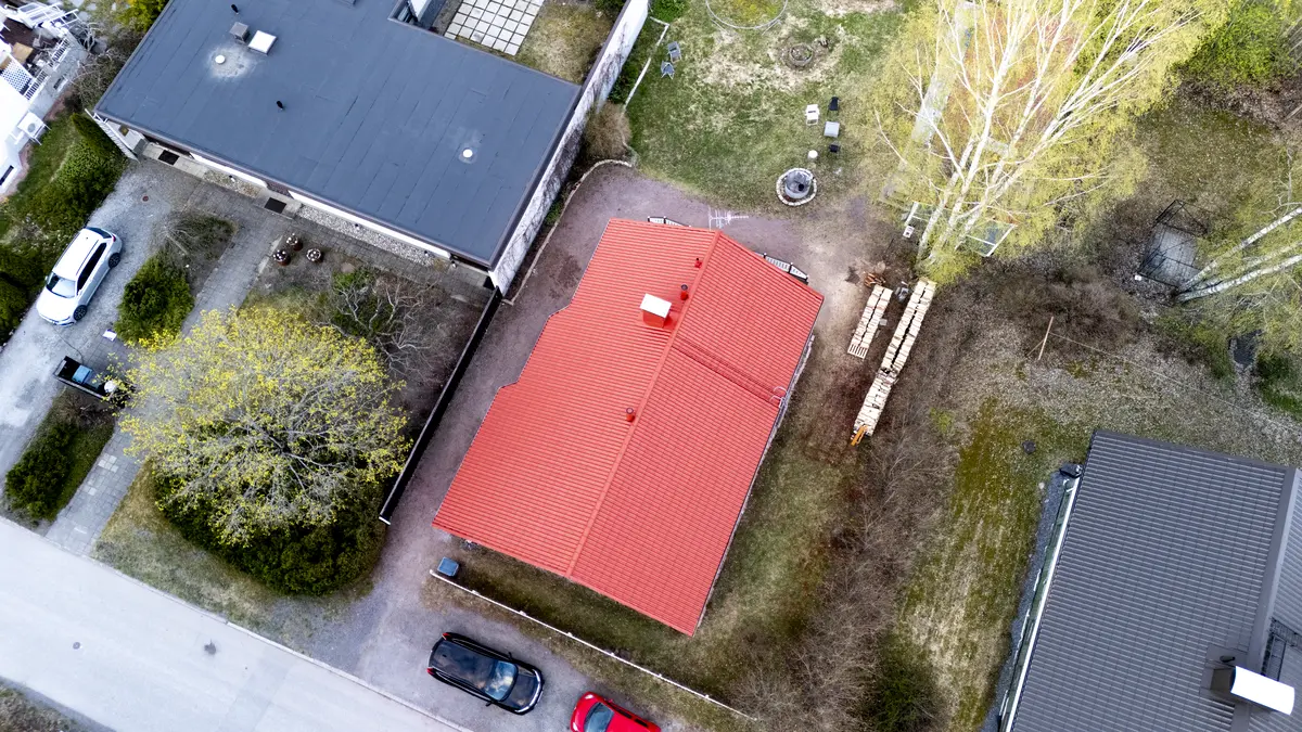 An aerial view of a house with a red roof