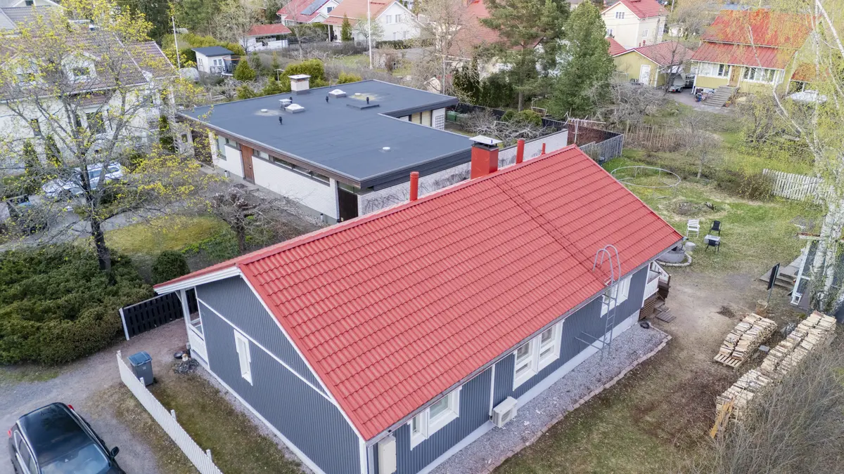 An aerial view of a house with a red roof