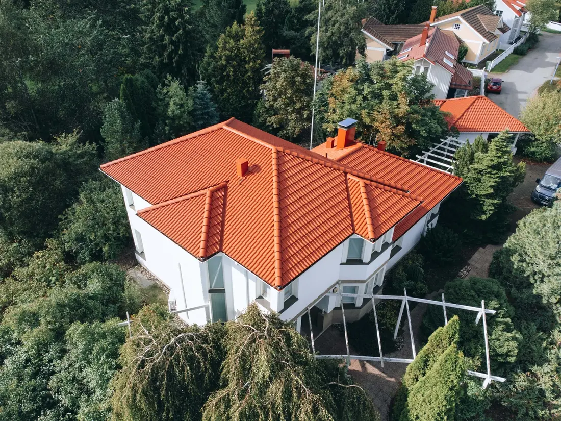 An aerial view of a house with a red tiled roof