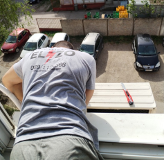 Slika majstora koji montira klimu