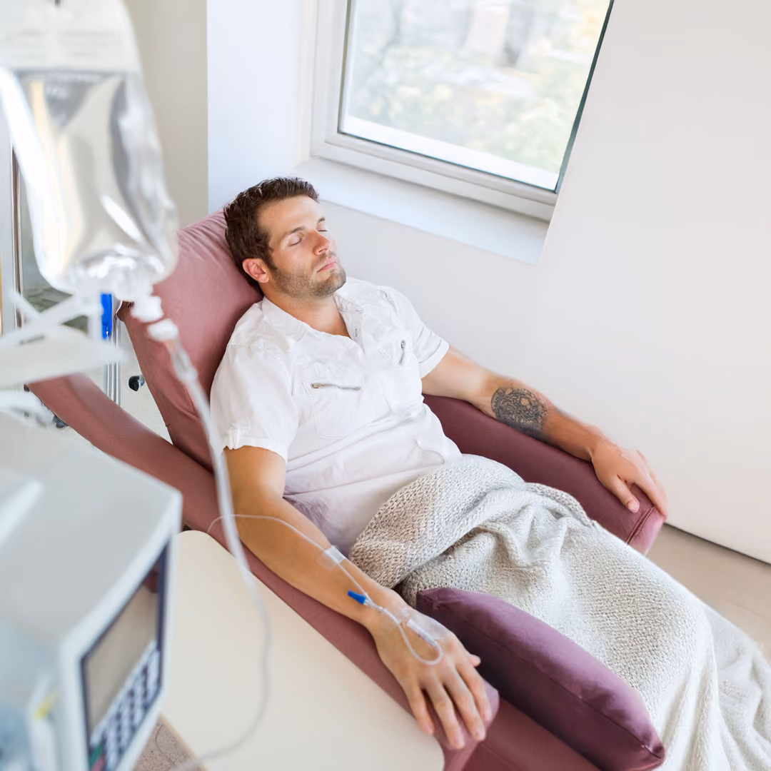 A patient is sitting in a chair getting iv ketamine therapy.