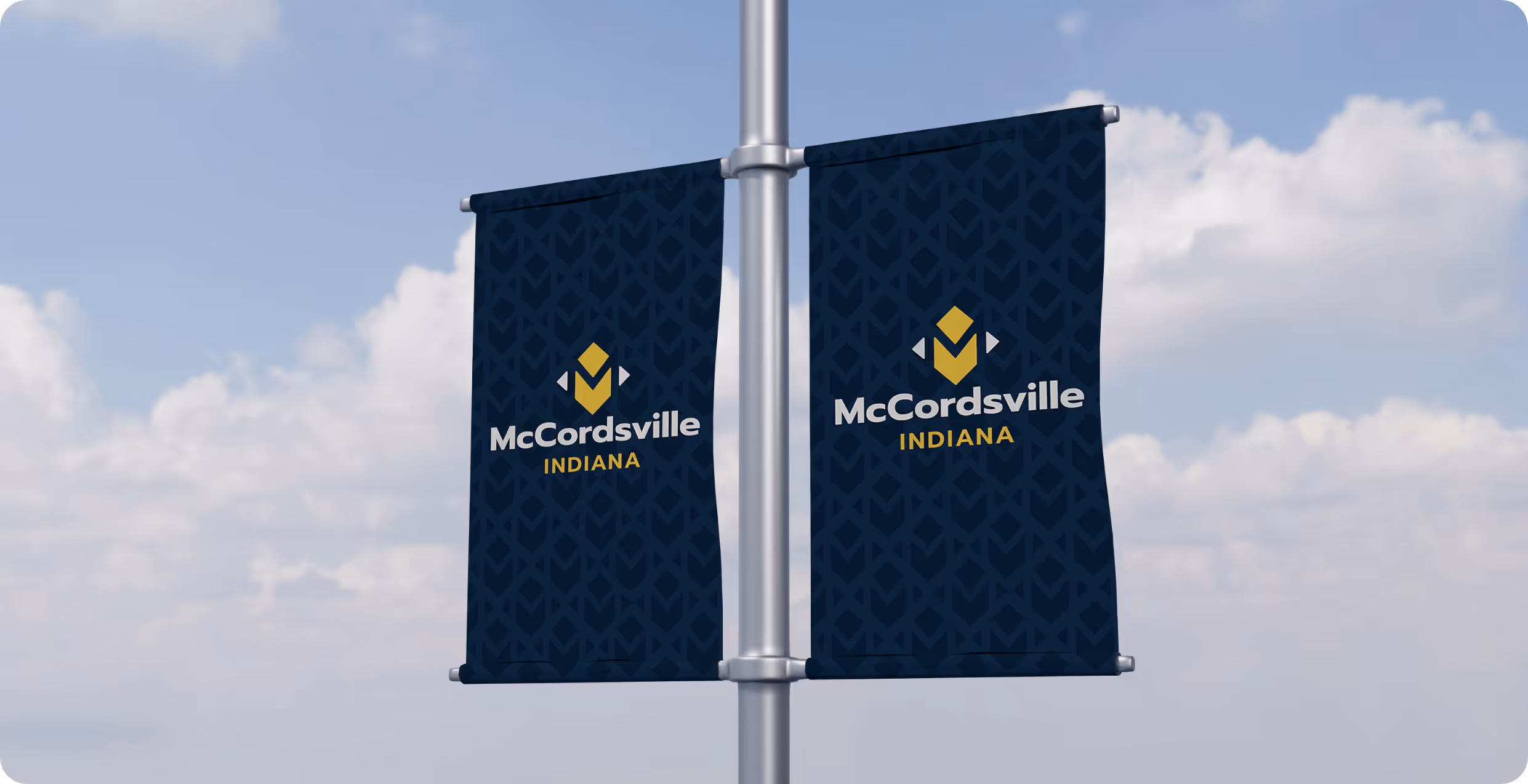 Two town pole banners of the McCordsiville logo with sky in background for the Town of McCordsville Indiana designed by AP The Creative.