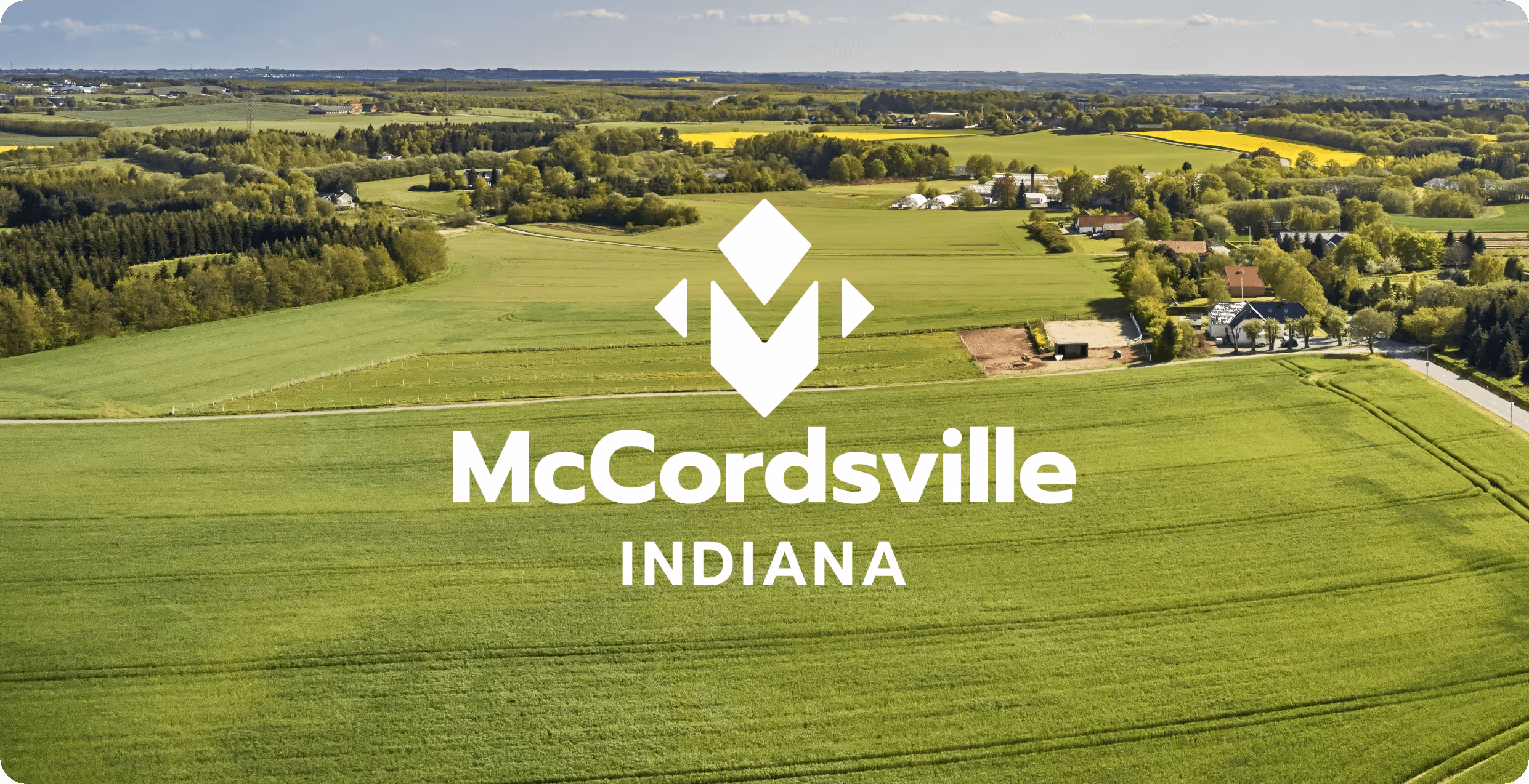 Field of green and trees with the Town of McCordsville Indiana logo in white designed by AP The Creative. 