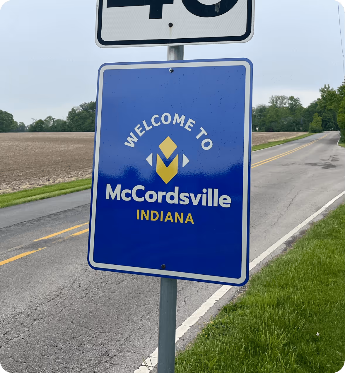 Street sign speed sign welcoming you to the Town of McCordsville Indiana designed by AP The Creative. 