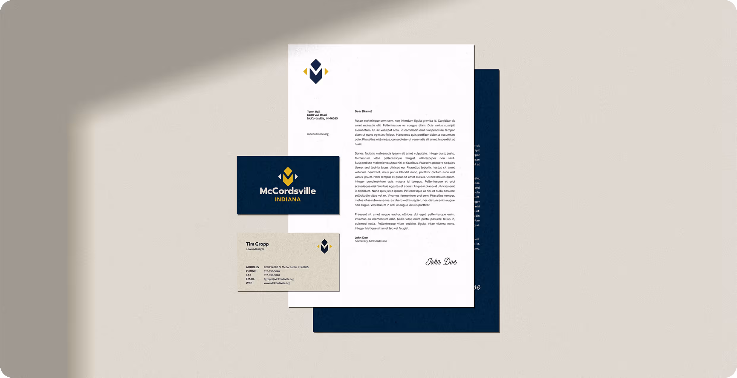Stationary items including business card front and back and a letterhead mockup for the Town of McCordsville Indiana designed by AP The Creative. 