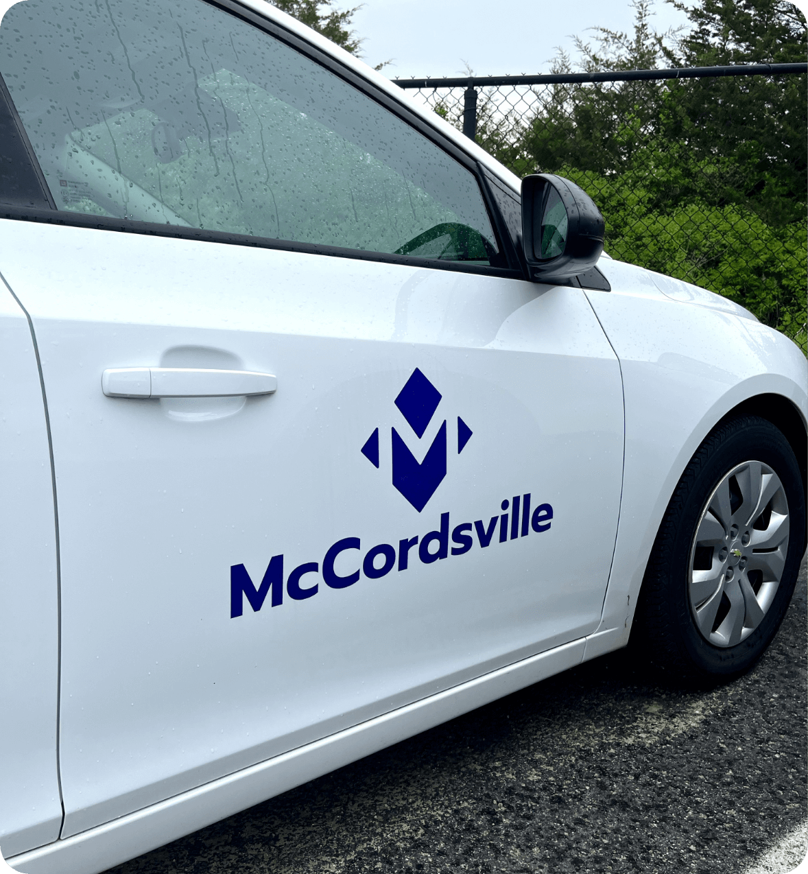 White car with the logo for the Town of McCordsville Indiana designed by AP The Creative. 
