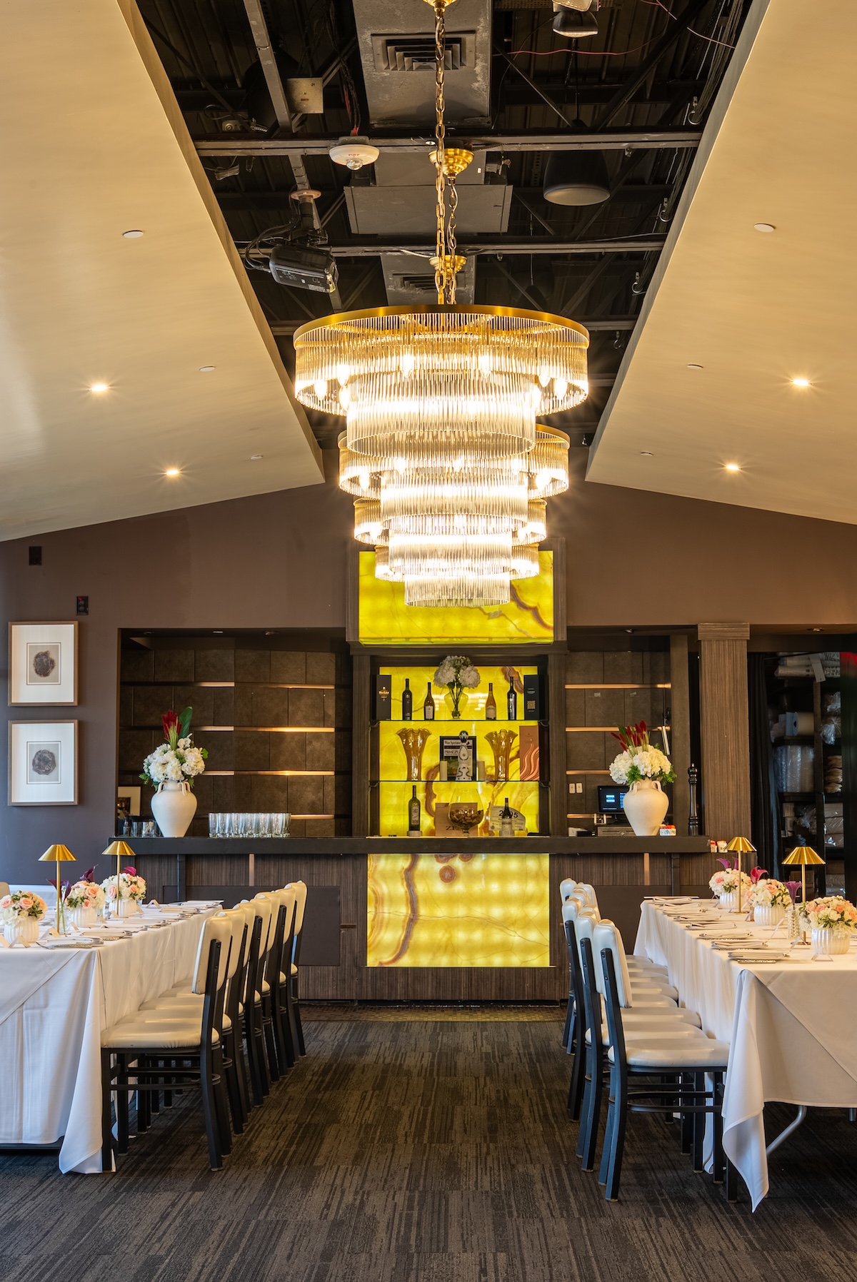 Our large private room with a glass wall on an entire side, curtained entrance, private bar and A/V capabilities. The large space makes it ideal for presentations, strolling events & more.