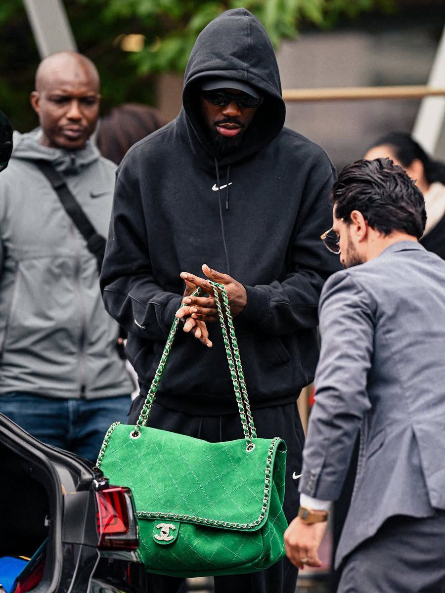 Image may contain Accessories Bag Handbag Adult Person Purse Clothing Hoodie Knitwear Sweater and Sweatshirt