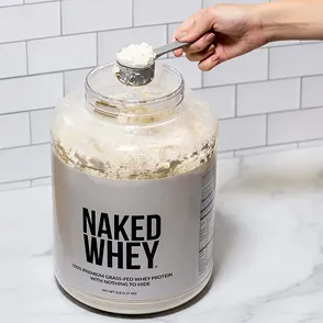 Naked Nutrition whey protein tub with a scoop.